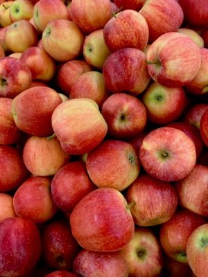 A vibrant pile of fresh, organic red apples showcasing their natural, delicious appeal.
