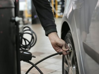 Photo of Man Standing Near Silver Vehicle