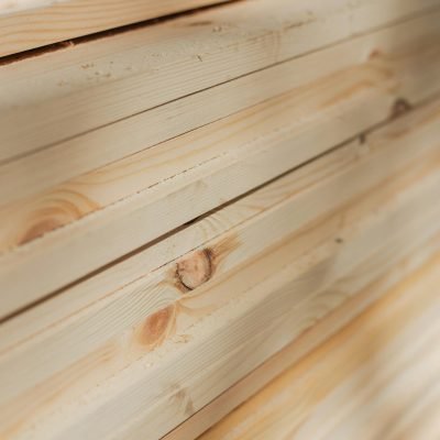 Close-up view of neatly stacked wooden planks highlighting their natural texture and grain.